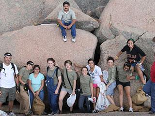 Group volunteer photo on rock