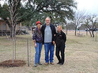 Volunteers next to planted tree